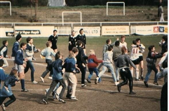 A group of people running on a field

Description automatically generated