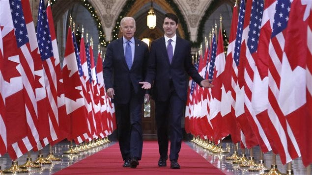 Prime Minister Justin Trudeau and US Vice-President Joe Biden walk down the Hall of Honour on Parliament Hill in Ottawa on Friday, December 9, 2016. 
