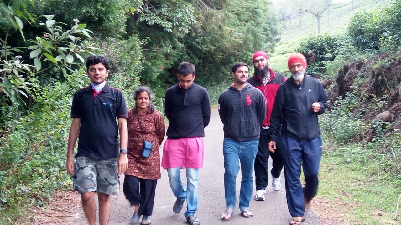 a group of people standing next to a tree