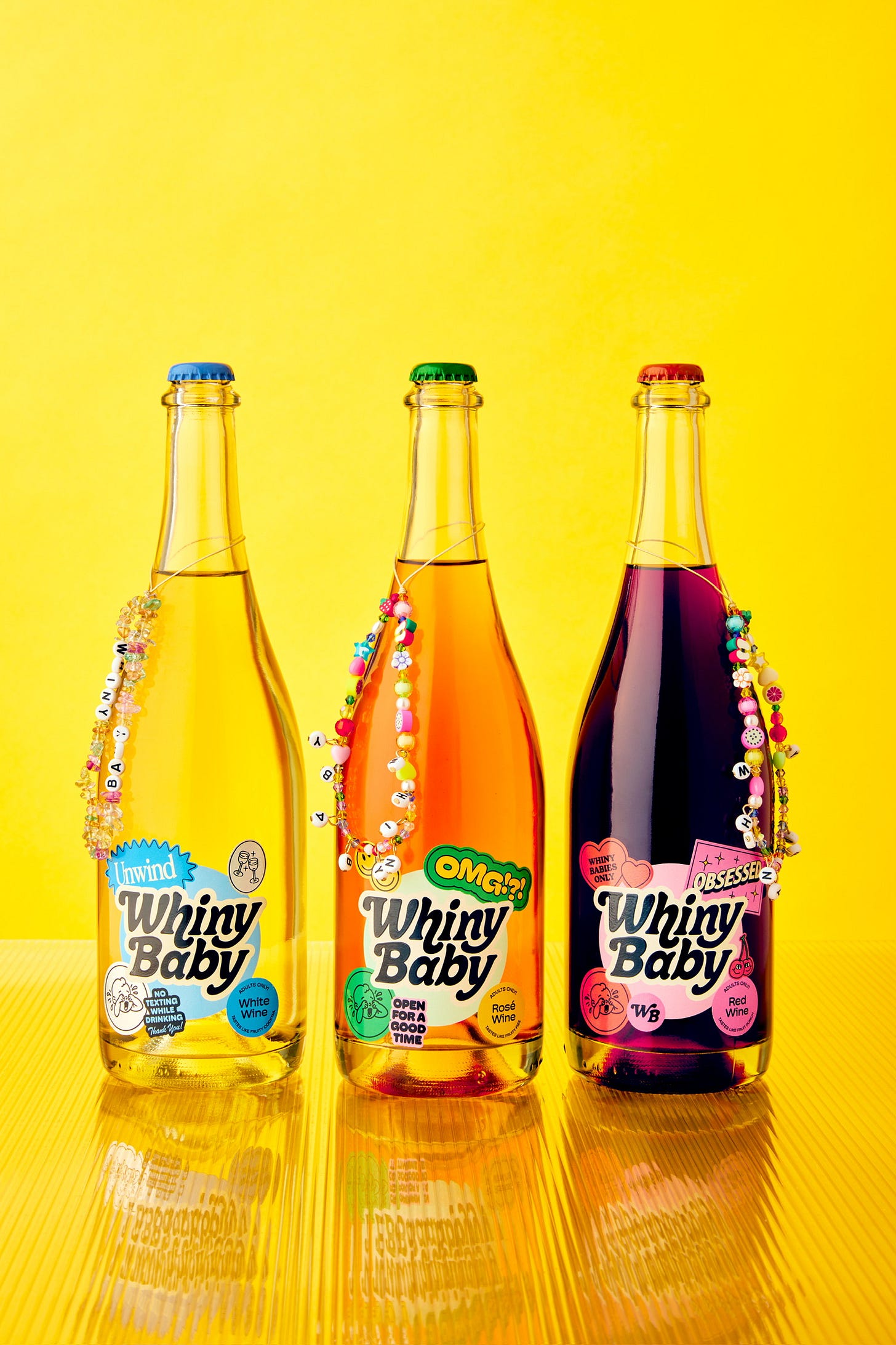 a bottle of red, white, and orange wine on a yellow background