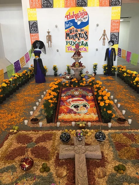 ofrendas decorated with candles, and colorful marigolds