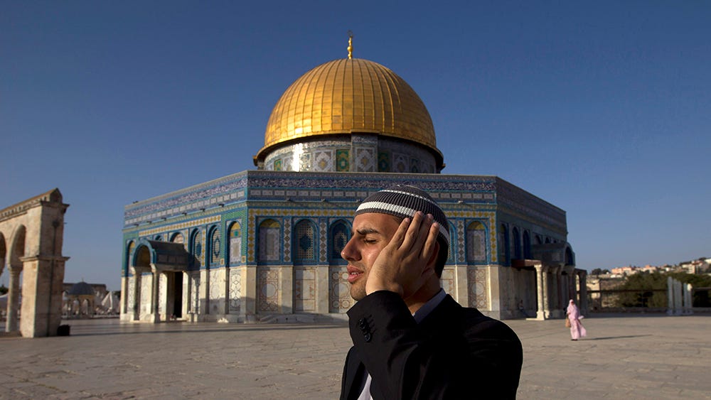 Palestinian muezzin of al-Aqsa Mosque at the Dome of the Rock in Jerusalem’s Old City, July 8, 2013