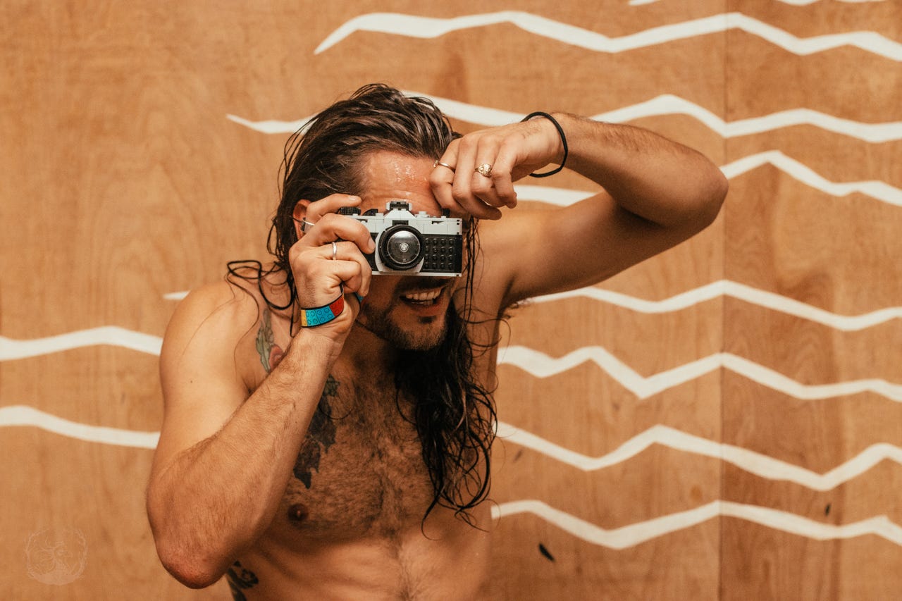 A photograph of a yoga teacher taking a photograph with a Lego camera. A photograph of a yoga teacher taking a photograph with a Lego camera.