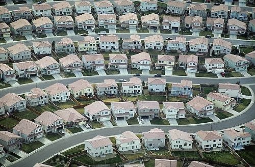 This may contain: an aerial view of many houses in the suburbs