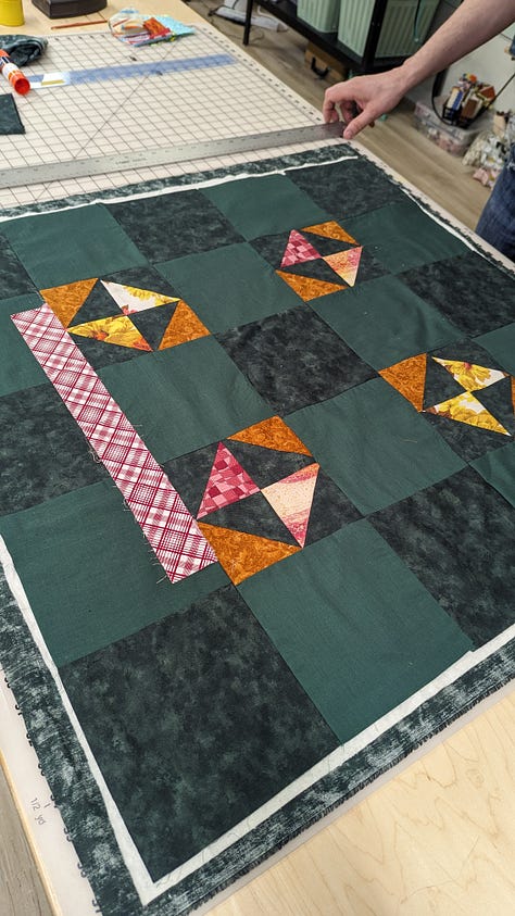 a muslin with alteration notes, an in progress quilt, a finished tote bag