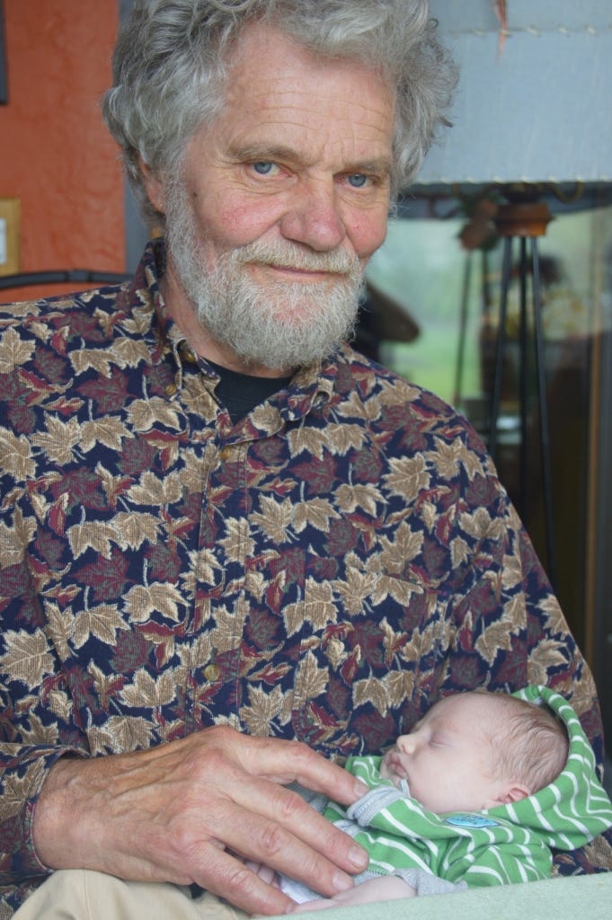 My dad holds the tiny newborn. My dad holds the tiny newborn.