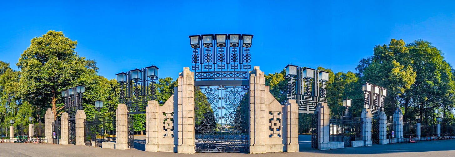 Wide shot of the main gate which is made of stone and wrought iron with art deco and art nouveau touches