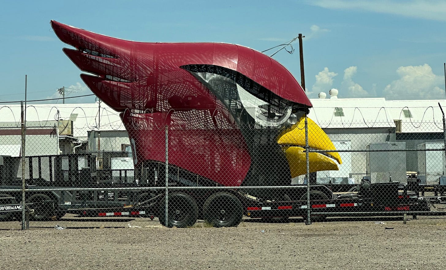 Big freaky Arizona Cardinals mascot head on a trailer.