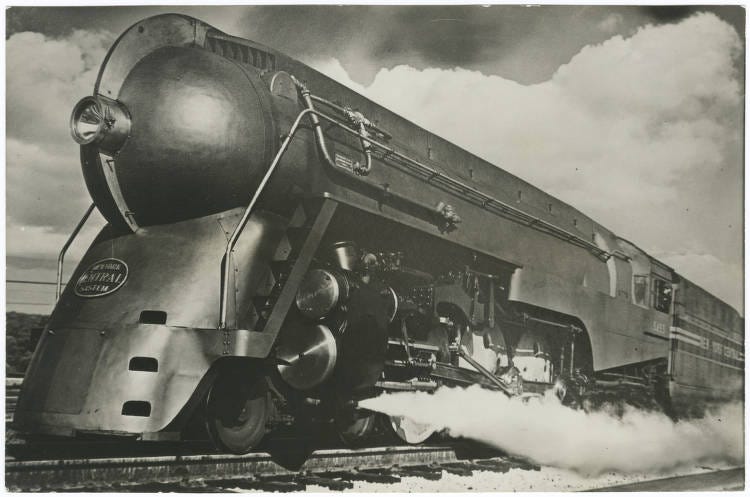 Black and white photo of sleek train steaming down a railroad track Black and white photo of sleek train steaming down a railroad track