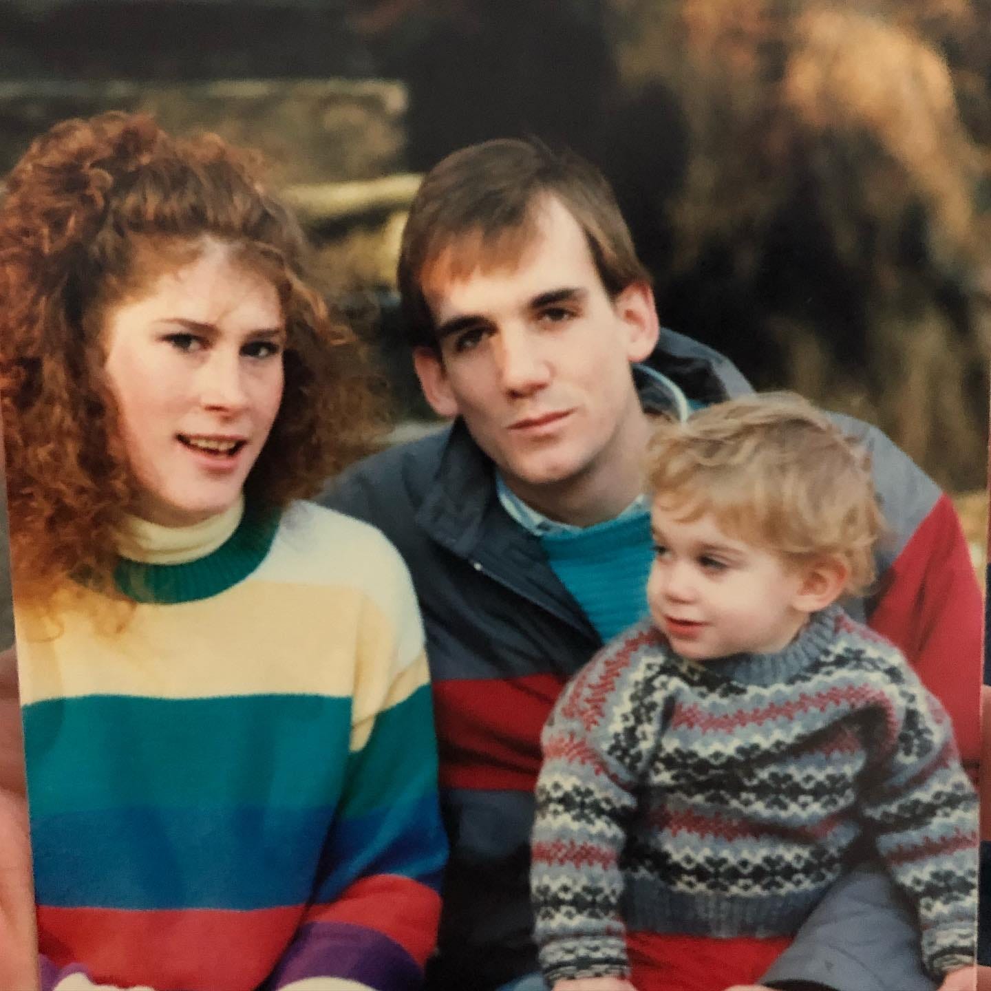 May be an image of 2 people, child, people sitting, people standing and outdoors