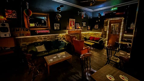 A gallery of images from inside the Star Bar, showing the random array of memorabilia on the walls, sofas and wingback chairs and a windowsill with objects insulting high heeled boots and an empty vase.
