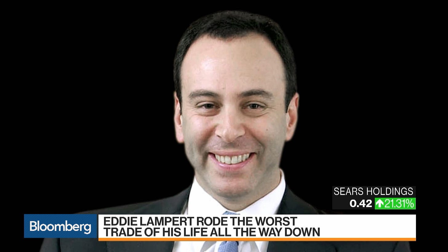 A white man in a corporate black haircut and suit smiles a truly horrifying smile. Below, a chiron: "Bloomberg. Eddie Lampert rode the worst trade of his life all the way down. In the corner: "Sears Holding .42 up 21.31%