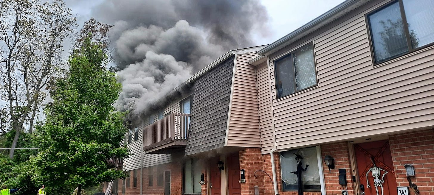 Dark gray smoke coming from a building