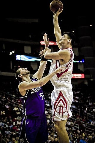 Yao Ming of the Houston Rockets shooting over Brad Miller of the Sacramento Kings Yao Ming of the Houston Rockets shooting over Brad Miller of the Sacramento Kings