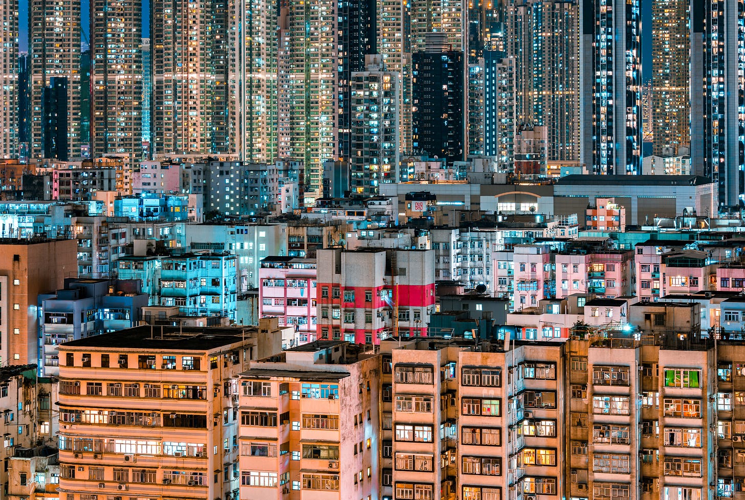 Dense residential towers in Sham Shui Po, Hong Kong, lit up at blue hour Dense residential towers in Sham Shui Po, Hong Kong, lit up at blue hour