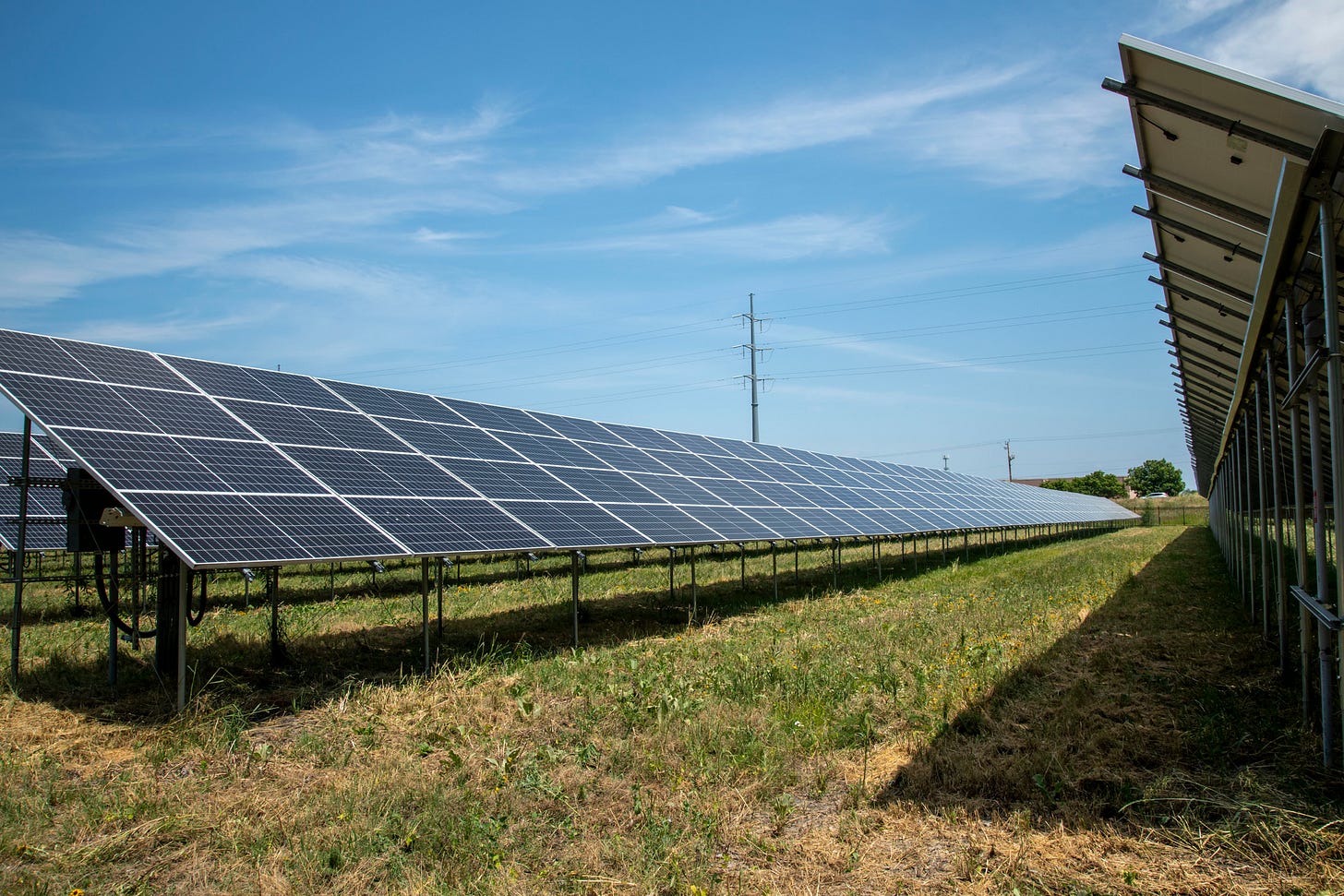A high tension electrical power pole is seen in the background of a solar array in Blaine, Minn. Credit: Michael Siluk/UCG/Universal Images Group via Getty Images A high tension electrical power pole is seen in the background of a solar array in Blaine, Minn. Credit: Michael Siluk/UCG/Universal Images Group via Getty Images