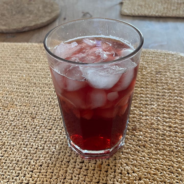 Hibiscus Tea concentrate, with cinnamon, orange peel, and ice.