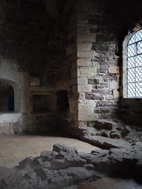 Photo of square open oven set in stone wall; Lines carved into stone wall from a distance, and close up