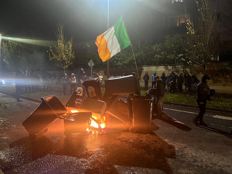 Protesters set light to wheelie bins during a major disturbance outside the Citywest Hotel, which is used to accommodate  international protection applicants. Photograph: Cian O'Connell