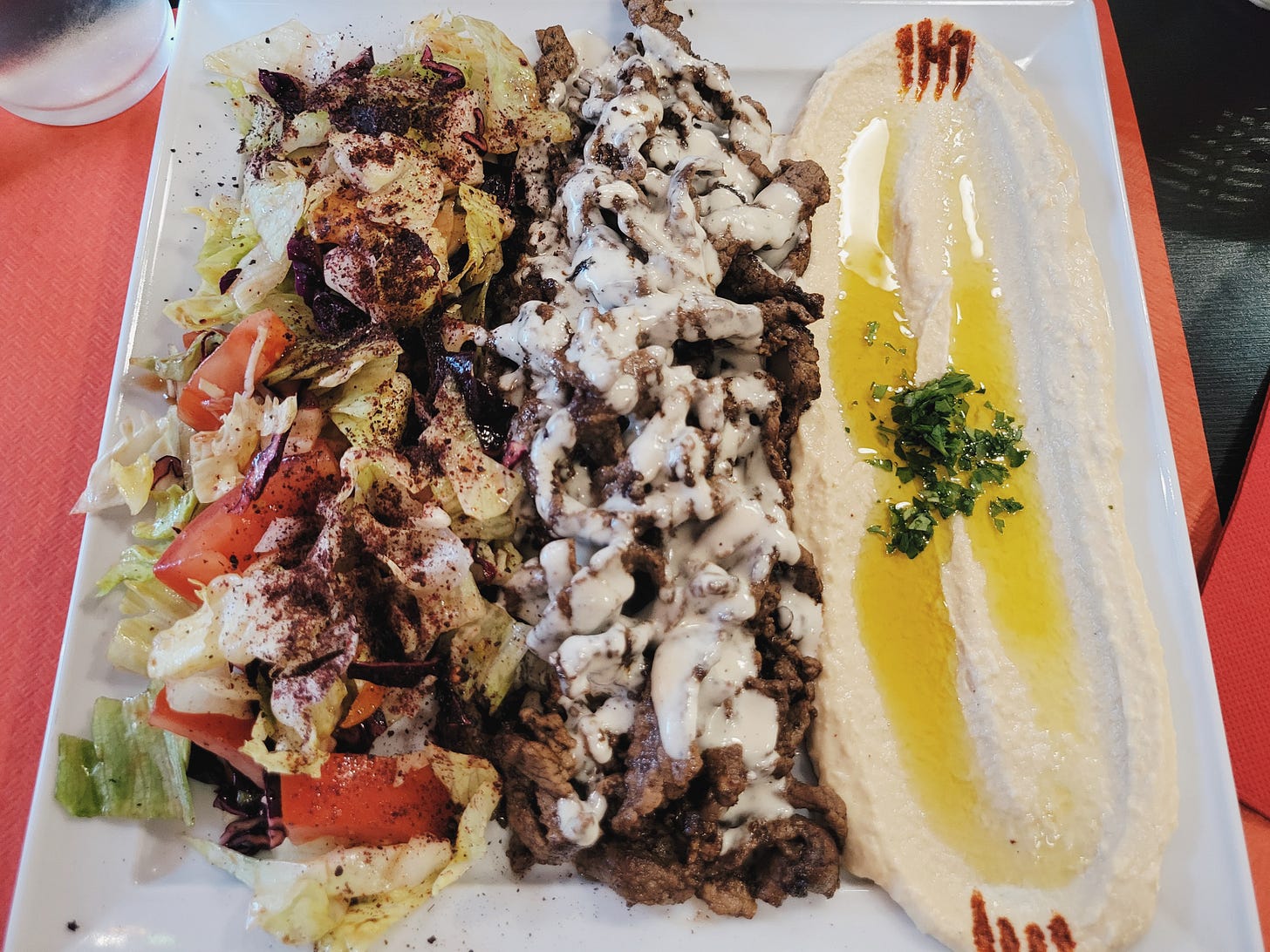 Grilled meat, salad, and hummus at Ristorante Middle East in Como Grilled meat, salad, and hummus at Ristorante Middle East in Como
