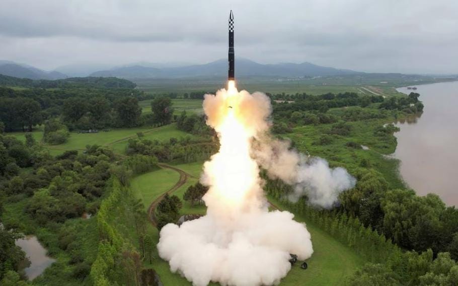 A Hwasong-18 missile rises above its exhaust plume during a North Korean test launch.