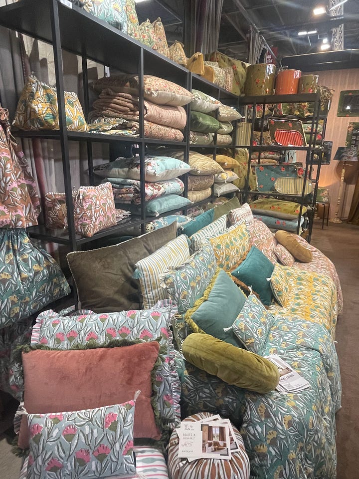 Dan Nazario and Alex Ortiz attending Maison & Objet Paris 2026 in January, photographed during TrendVision trend scouting in Paris. Maison & Objet Paris 2026 exhibitor display featuring layered cushions, floral textiles, and mixed patterns showcasing home décor trend direction.