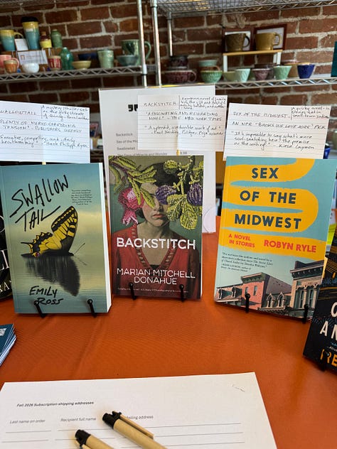 Images of Galiot Press books displayed on a table inside a café