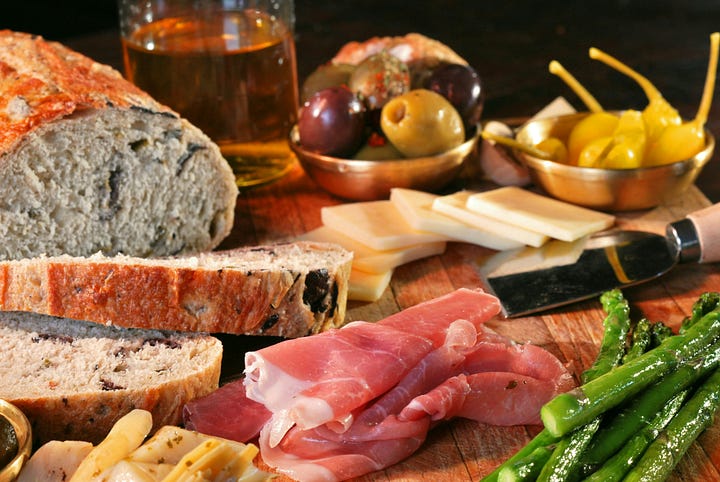 Sandwich coming together. Bread, meat and cheese with olives. Photos by Marco Palumbo and David B. Townsend via Unsplash