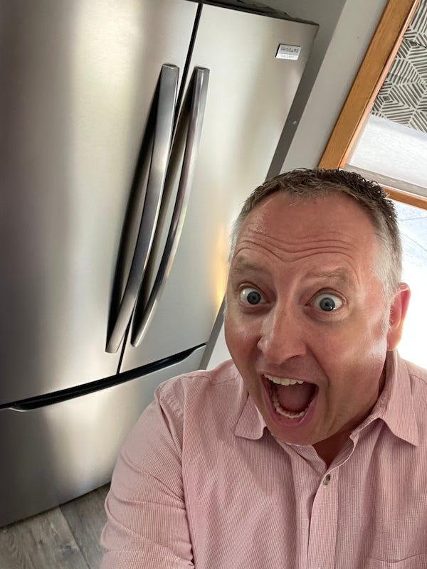 Dr. Dave looking overly excited about the new refrigerator