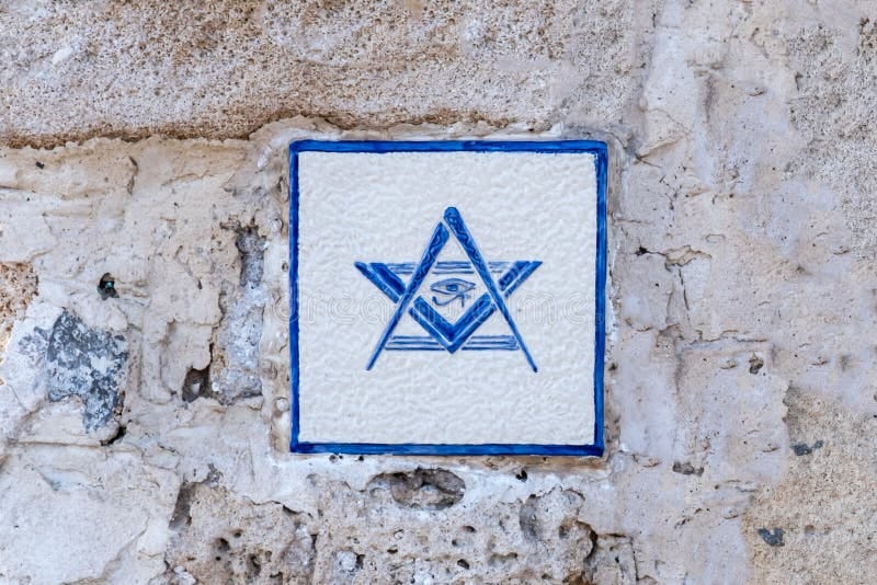Tel Aviv-Yafo, Israel - December 19, 2021: Freemason emblem on the old ruined wall. Tel Aviv-Yafo, Israel - December 19, 2021: Freemason emblem on the old ruined wall.
