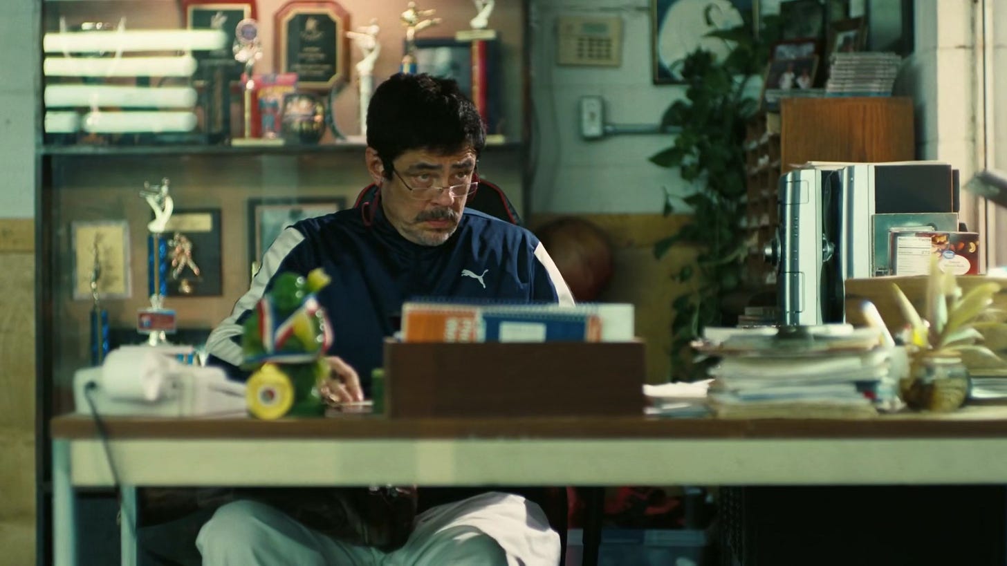 Sensei at desk looks up from his phone