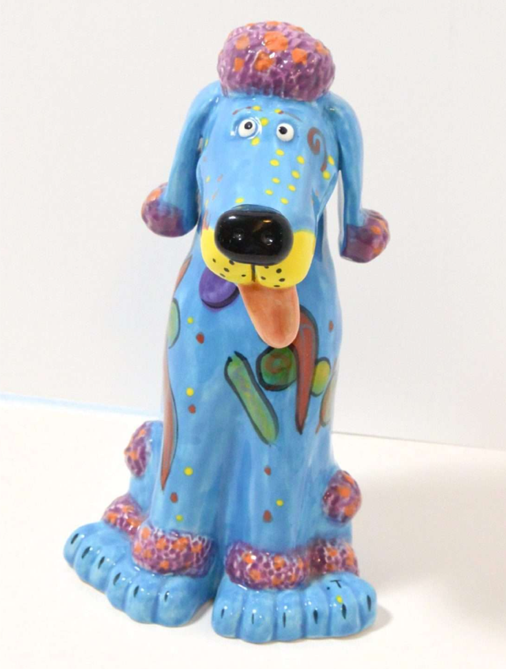 A blue dog statue with a hat and tongue out

AI-generated content may be incorrect.