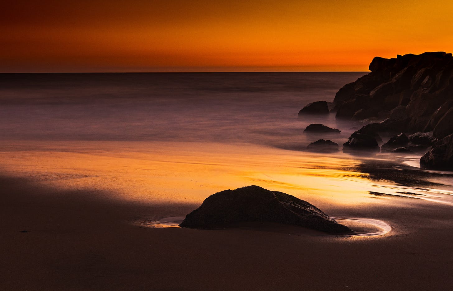 decorative photo of red sunlight over the beach and ocean