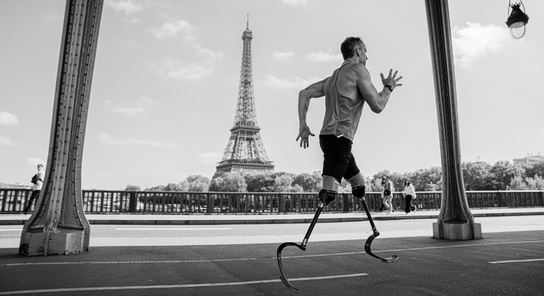 A black and white picture of Richard Whitehead MBE running across Paris A black and white picture of Richard Whitehead MBE running across Paris