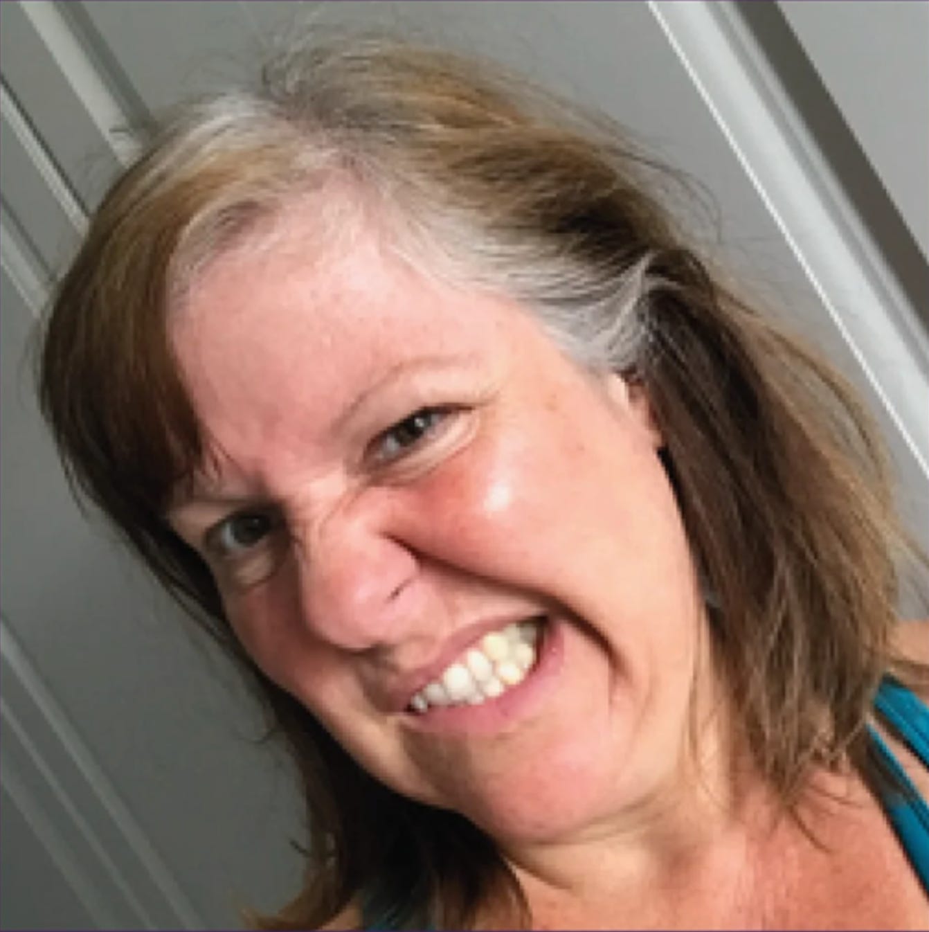 Photo of Julia Wallis with greying hair. 