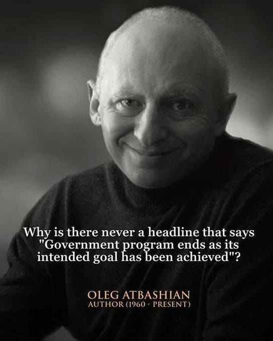 Oleg Atbashian, a bald man with a slight smile, wearing a dark sweater, against a dark background. Text overlay reads, "Why is there never a headline that says 'Government program ends as its intended goal has been achieved'?" and "OLEG ATBASHIAN AUTHOR (1960 - PRESENT)".