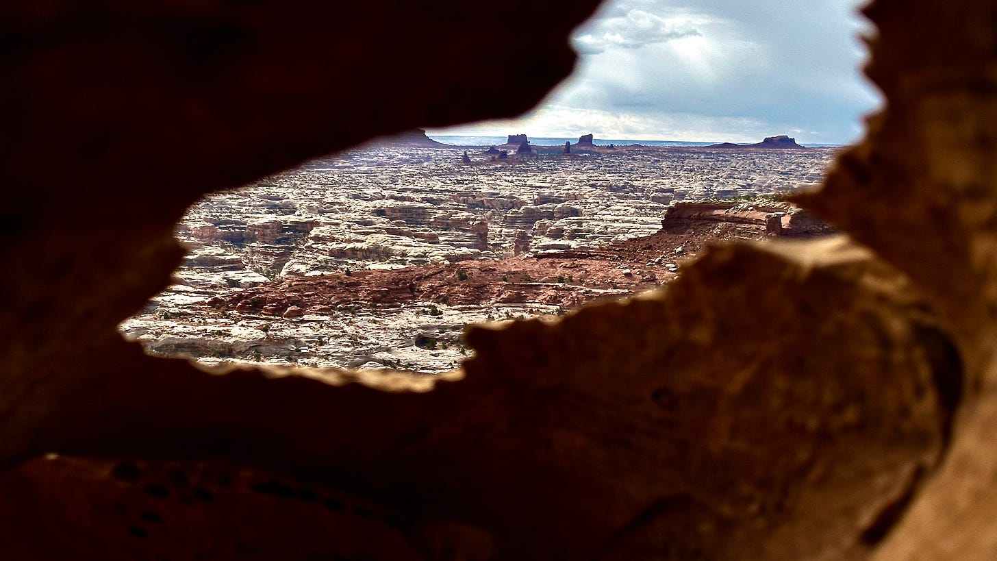 A view of a city from a rock window

Description automatically generated