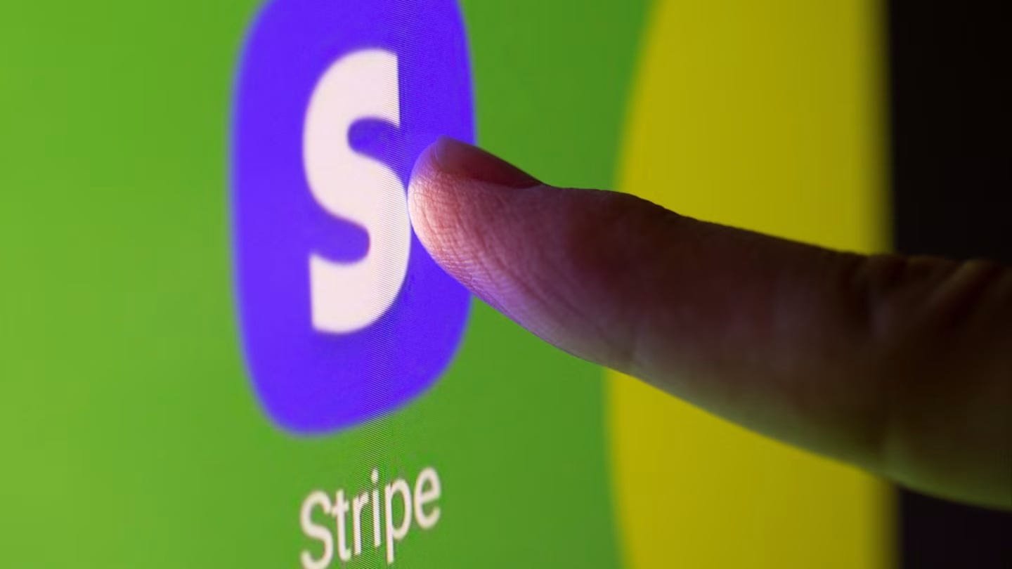 A finger touches a screen displaying the Stripe app logo, a white "S" on a purple background, with "Stripe" written below.
