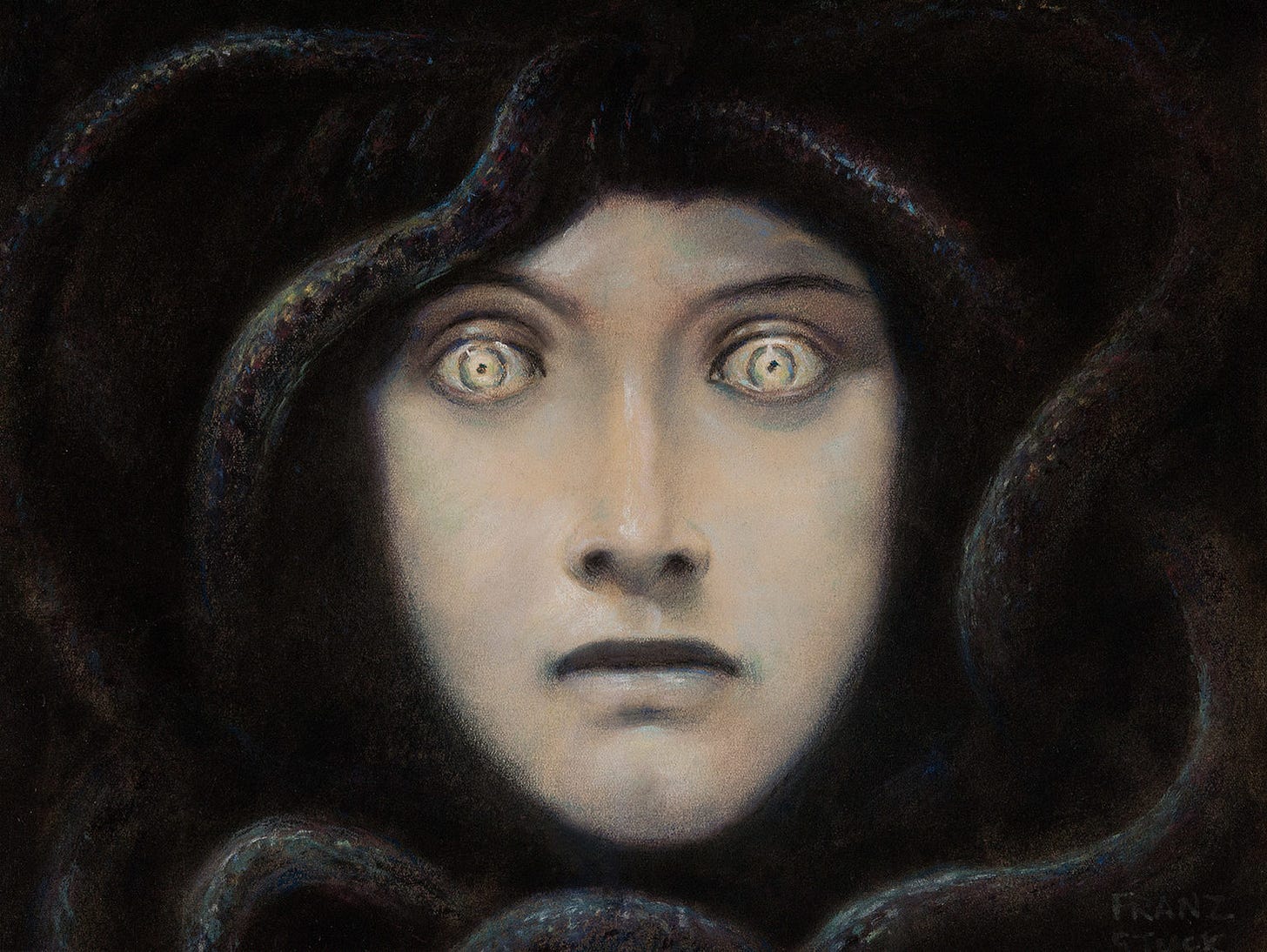 A pale woman's face staring straight out, framed by dark coiling snakes A pale woman's face staring straight out, framed by dark coiling snakes