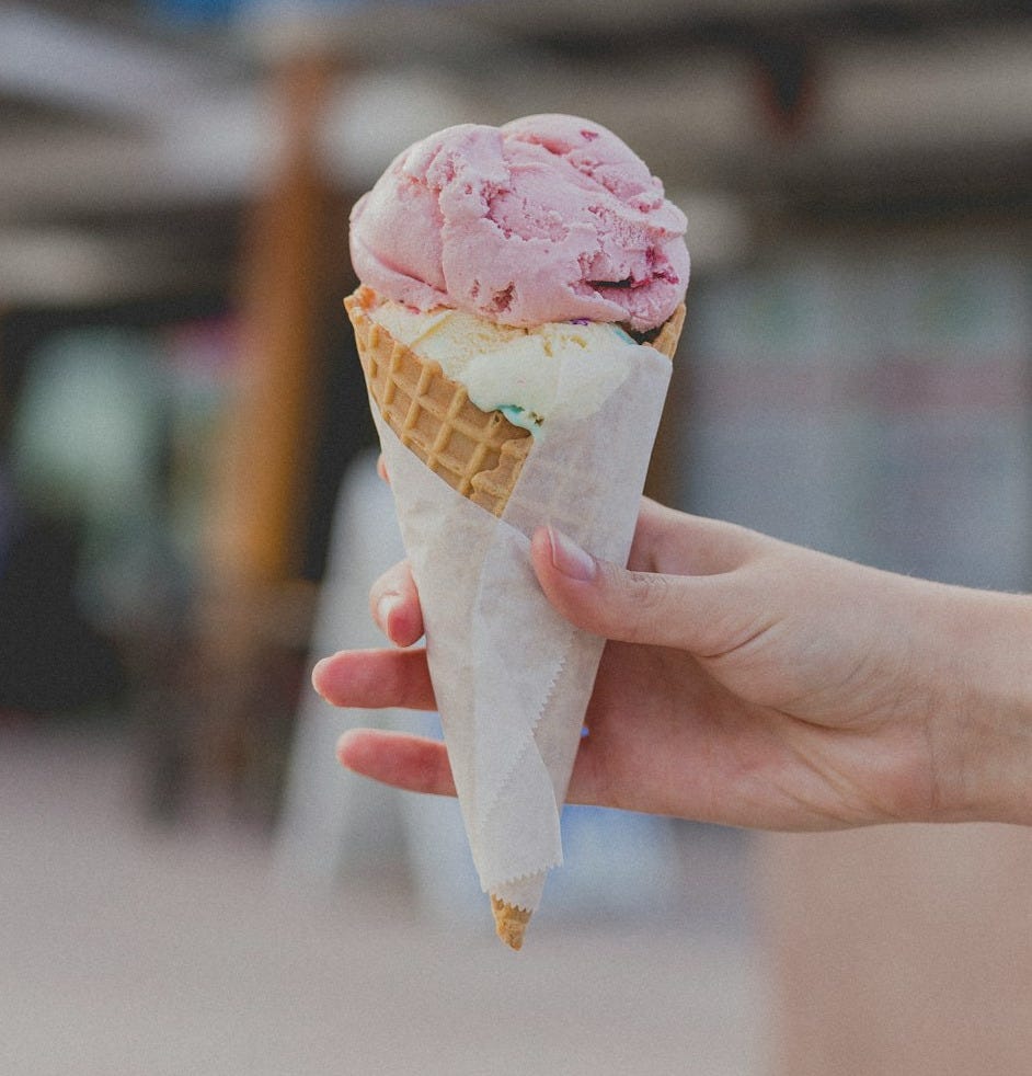 person holding strawberry ice cream