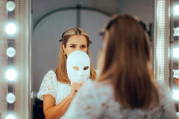 Sad Woman Wearing a White Mask Looking in the Mirror Shy introvert person acting with a social facade to cover herself Eliminate anxiety stock pictures, royalty-free photos & images
