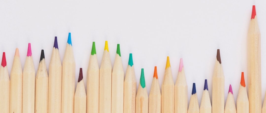 colored pencil lined up on top of white surface