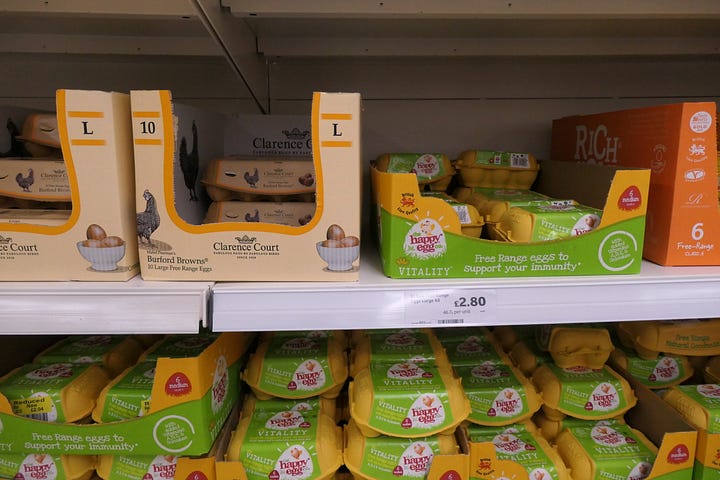 Crates of eggs on a shelf, and a brunch plate.