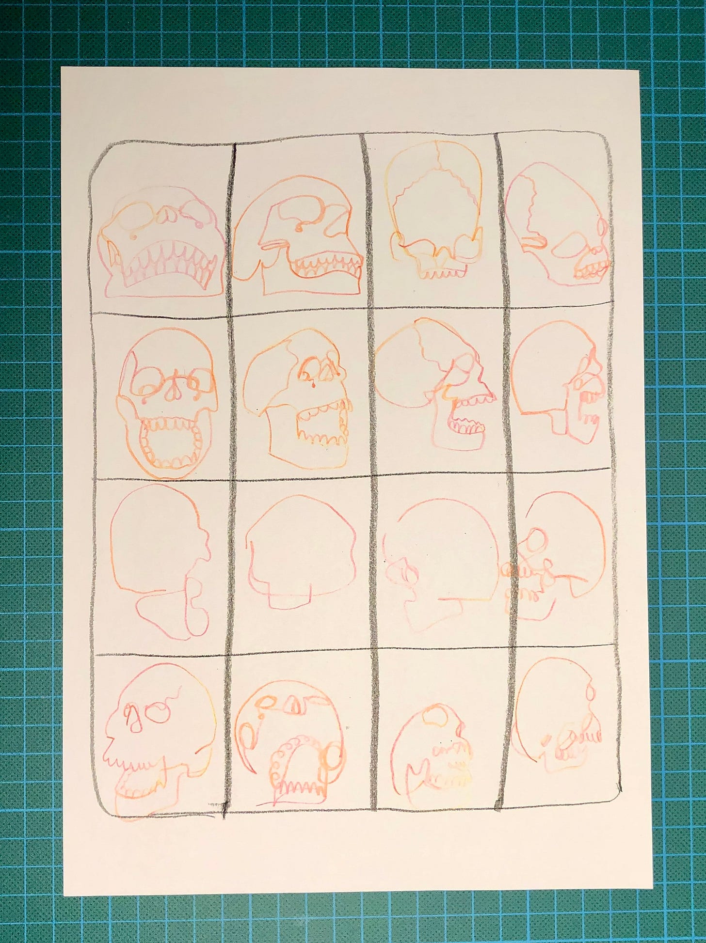 Photo de la feuille A4 sur laquelle j'ai dessiné 16 crânes dans une grille de 4 x 4 cases.