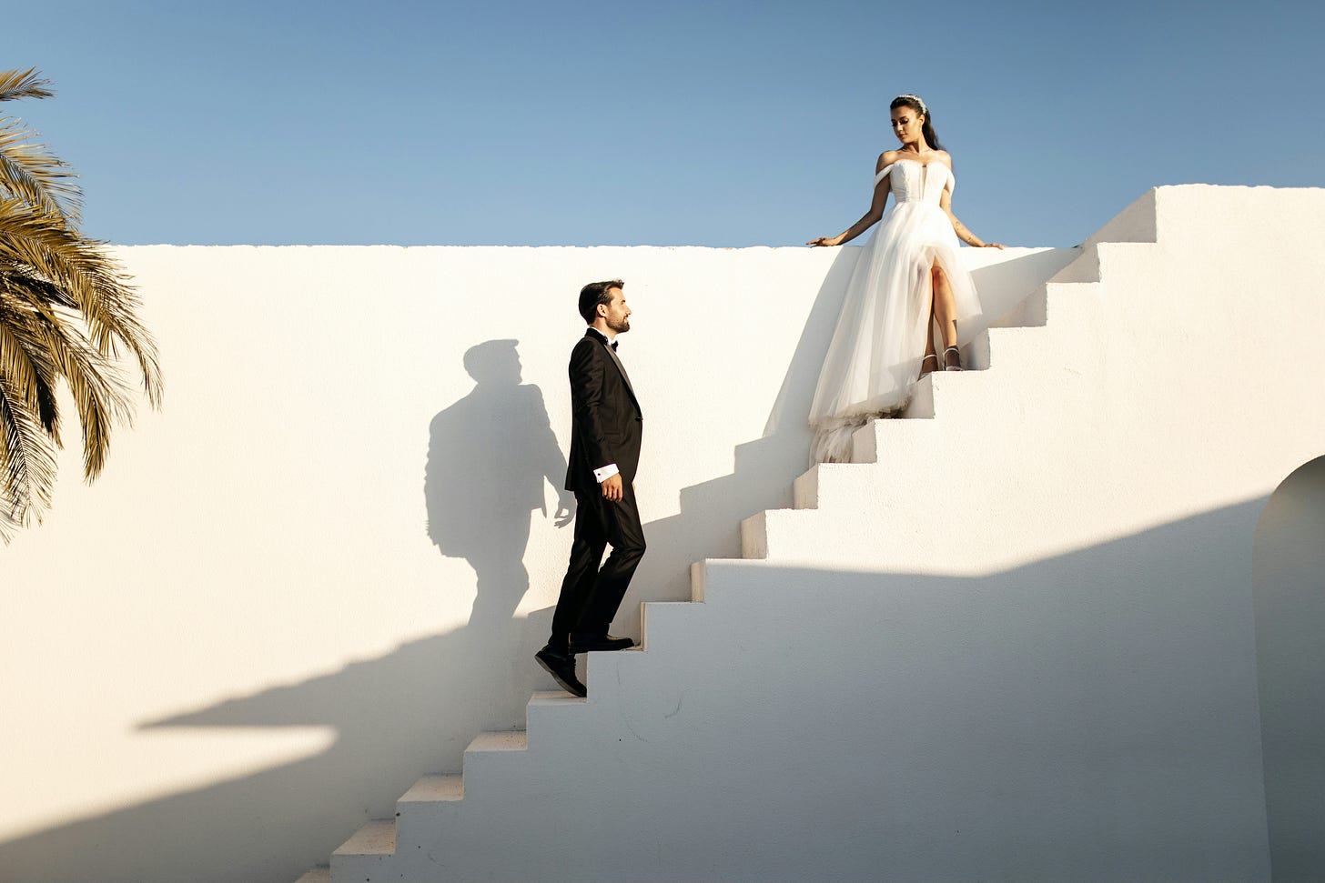 a bride and groom on an outdoor staircase
