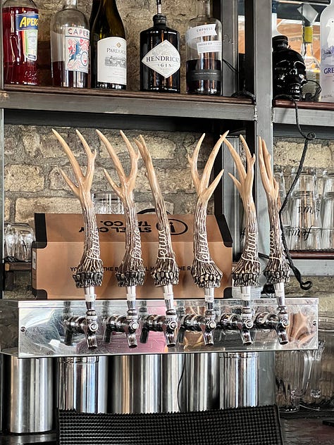 two drink menues and a picture of deer horn bar pulls that look like chicken feet