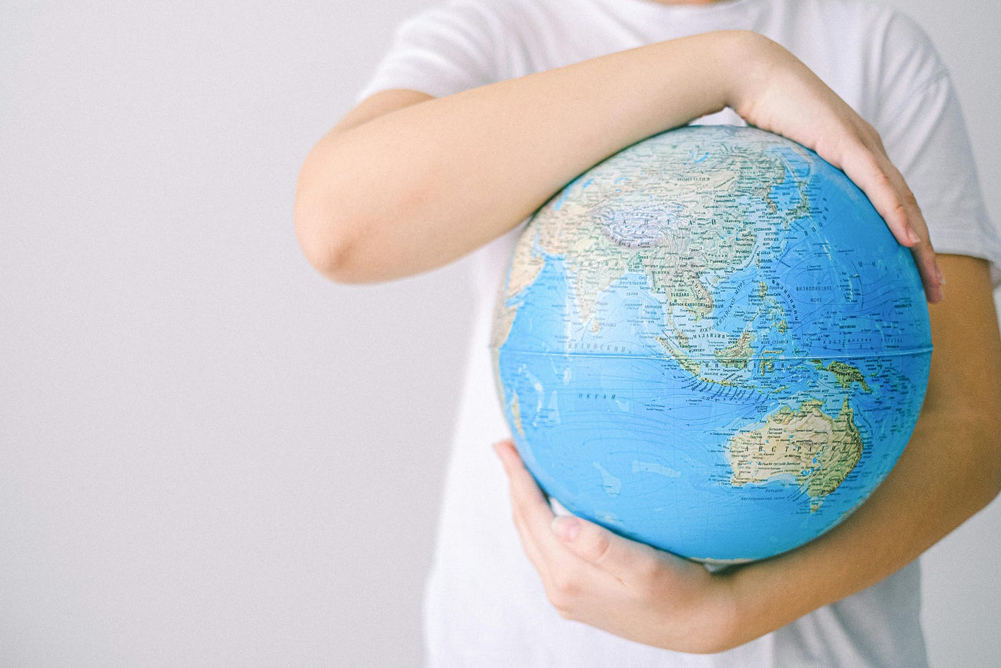 Arms around a globe