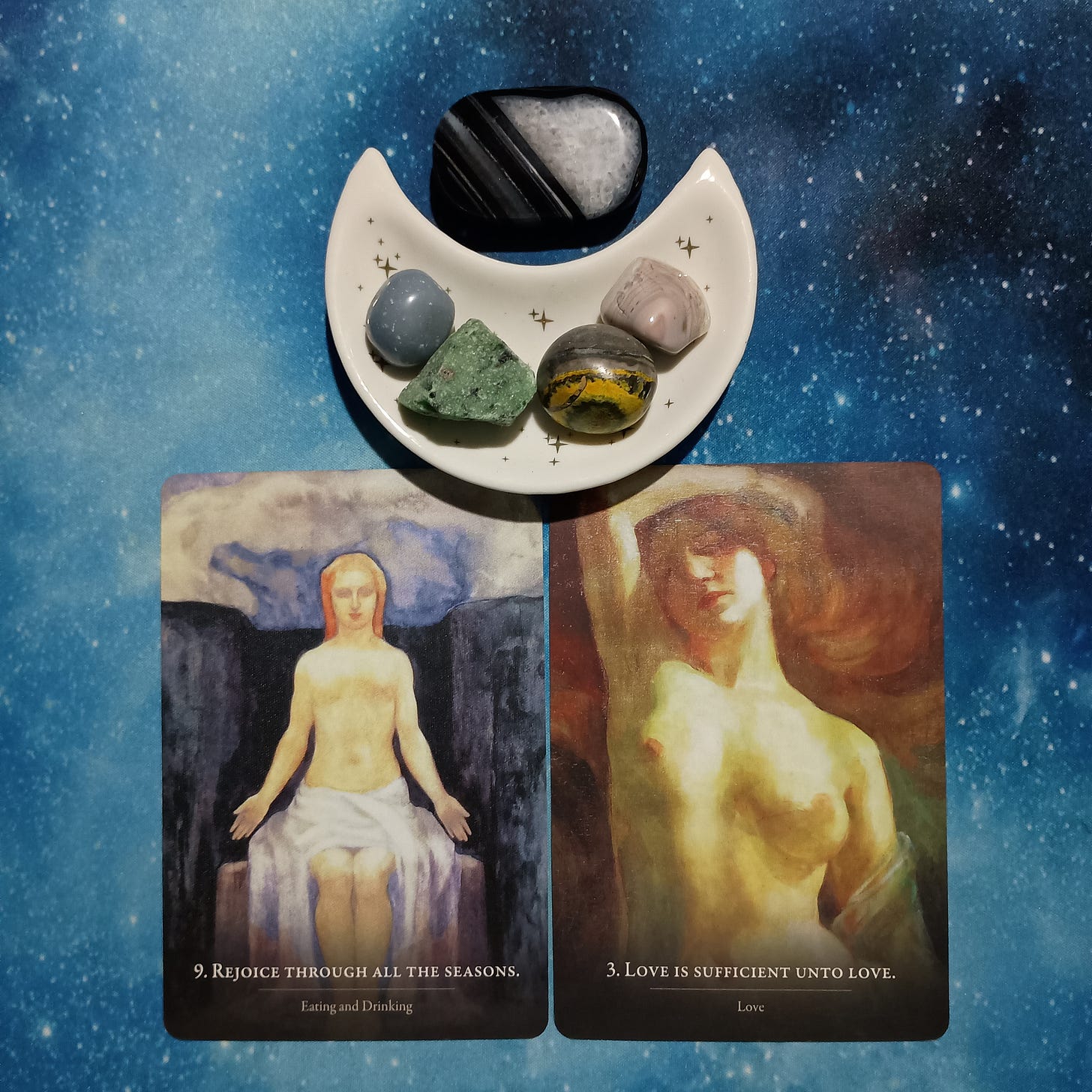 Flow with the Turning of the Wheel: A Message From the Universe, 2 Prophet Oracle cards and crystals on a starry blue background