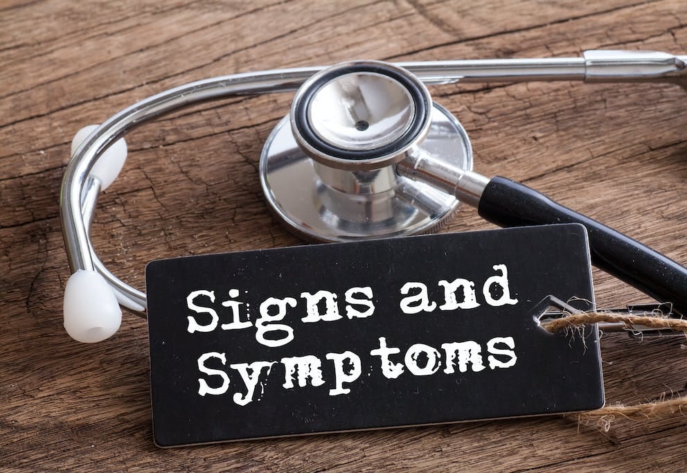 Stethoscope on wood with Signs and Symptoms