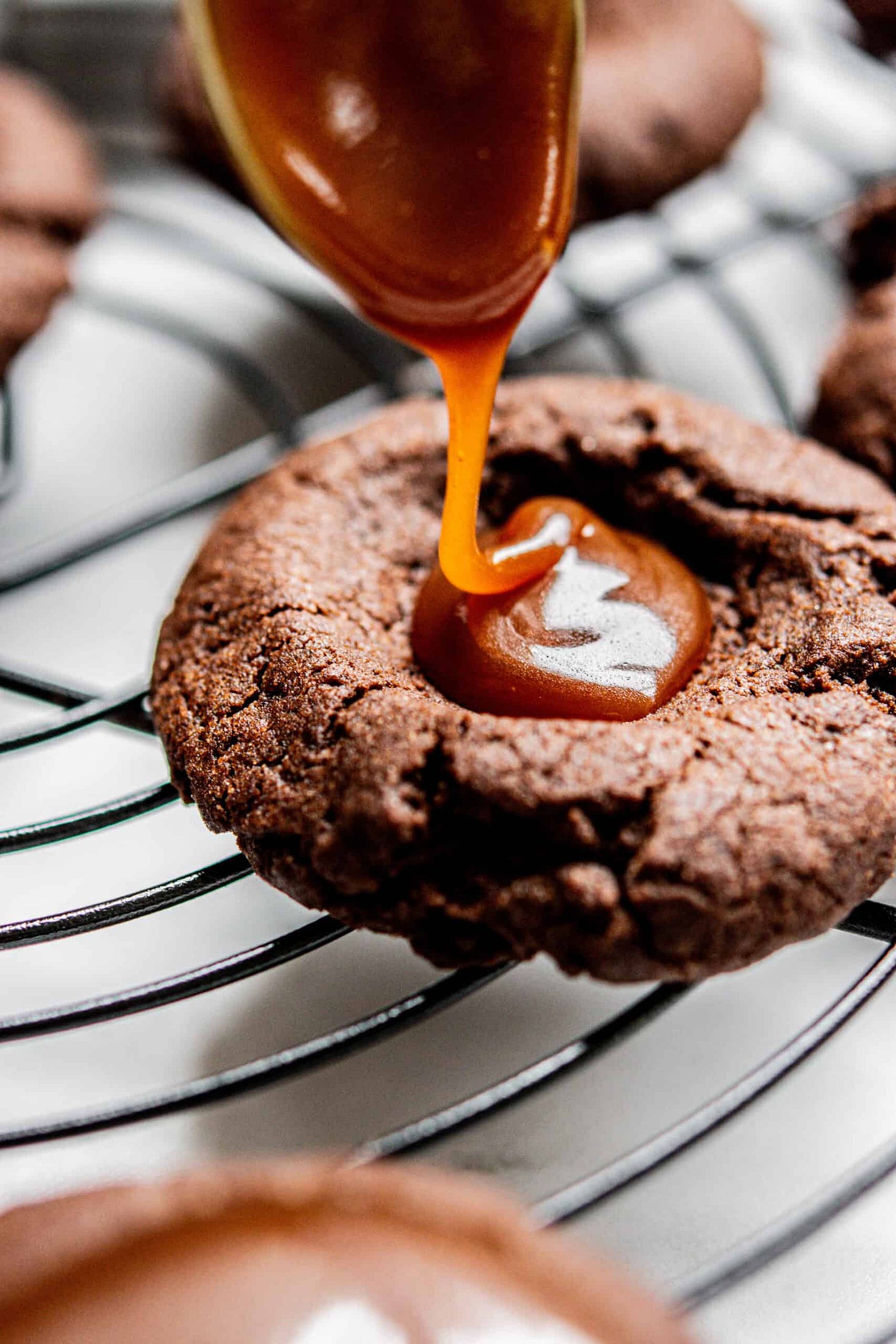 Caramel being dolloped on to cookie.